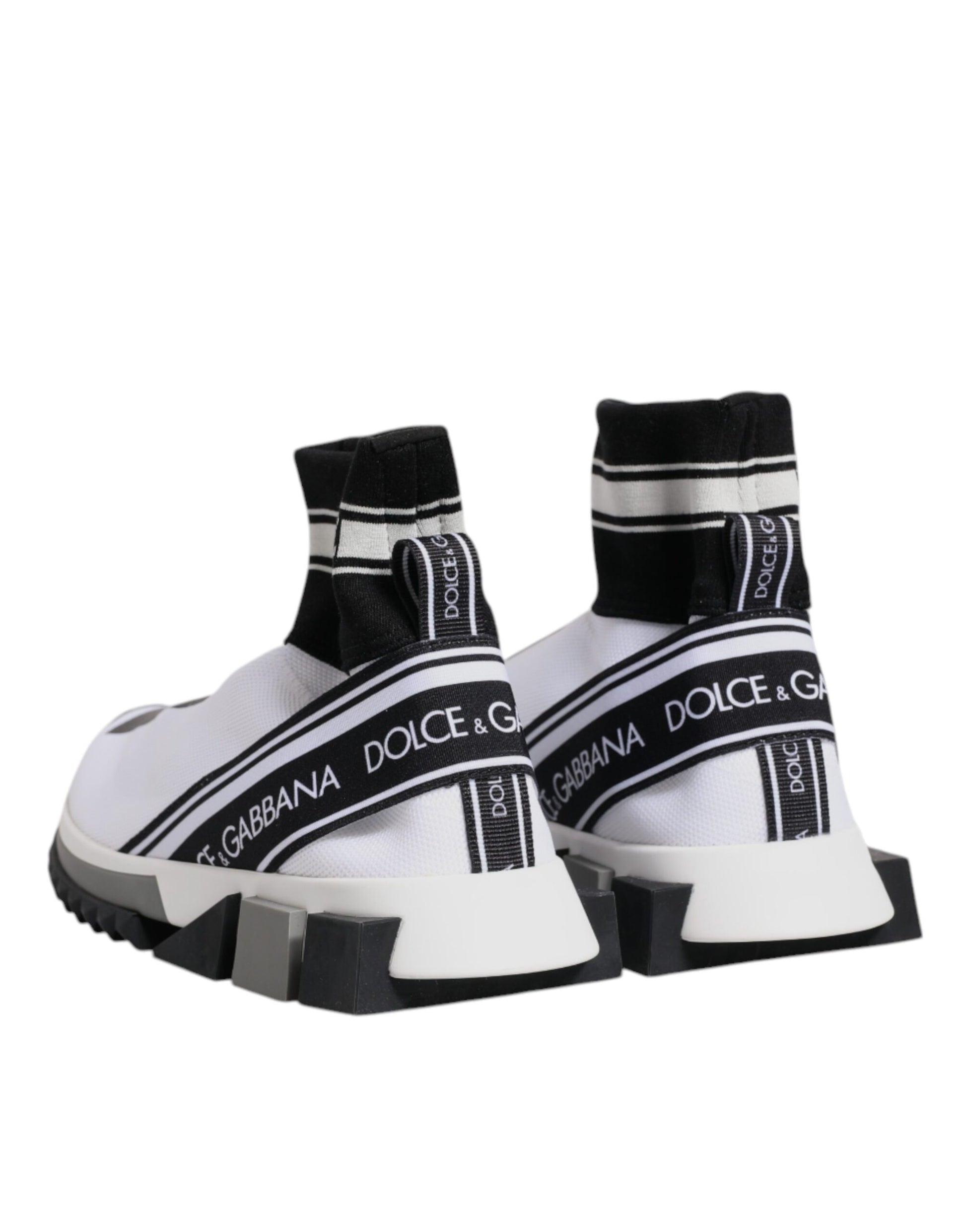 Pair of white sneakers with black and white stripes on sides