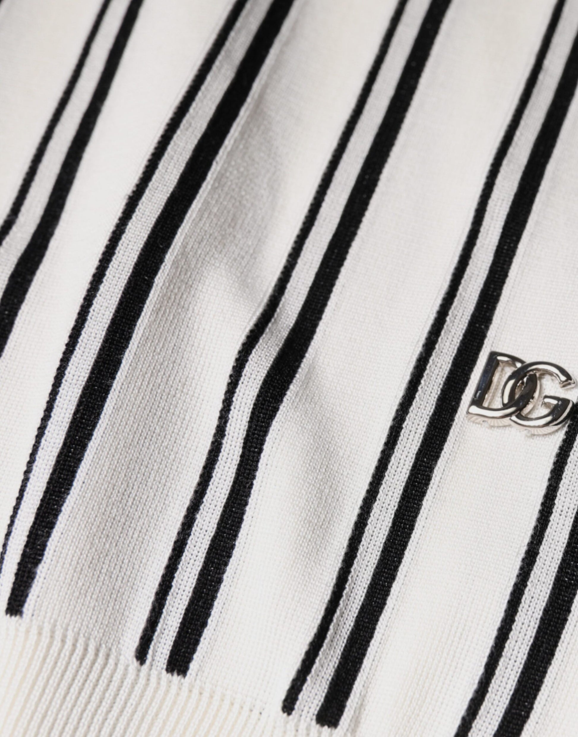 Black and white striped sweater with a small logo on the left chest area