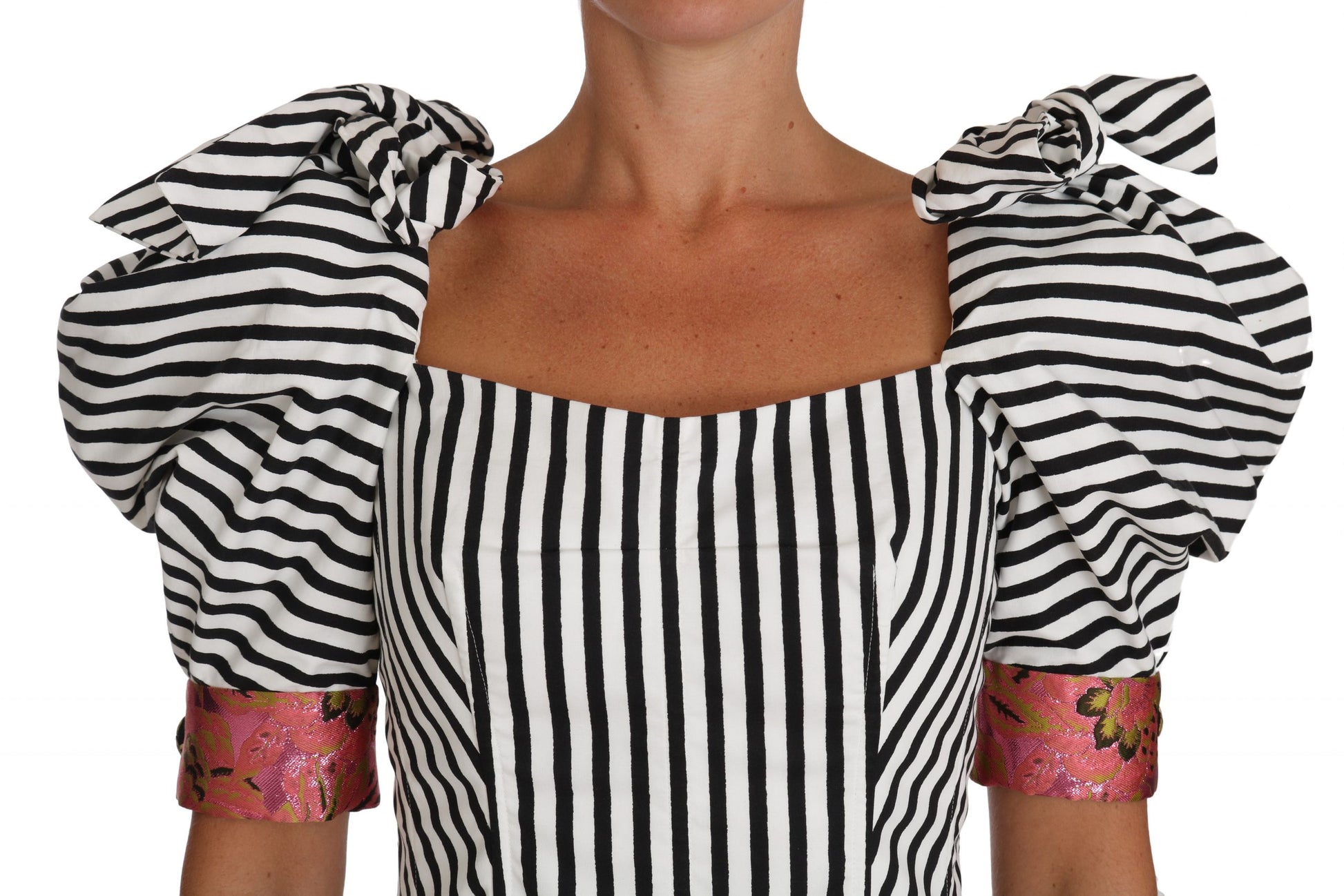 Black and white striped sleeveless dress with ruffled shoulders and pink accents