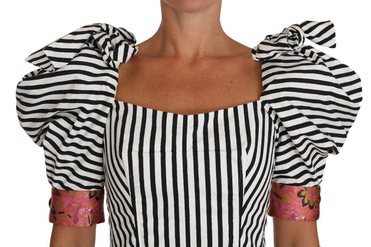 Black and white striped sleeveless dress with ruffled shoulders and pink accents