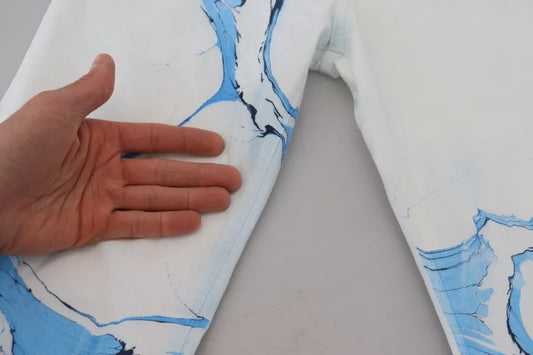 Hand measuring blue and white patterned fabric
