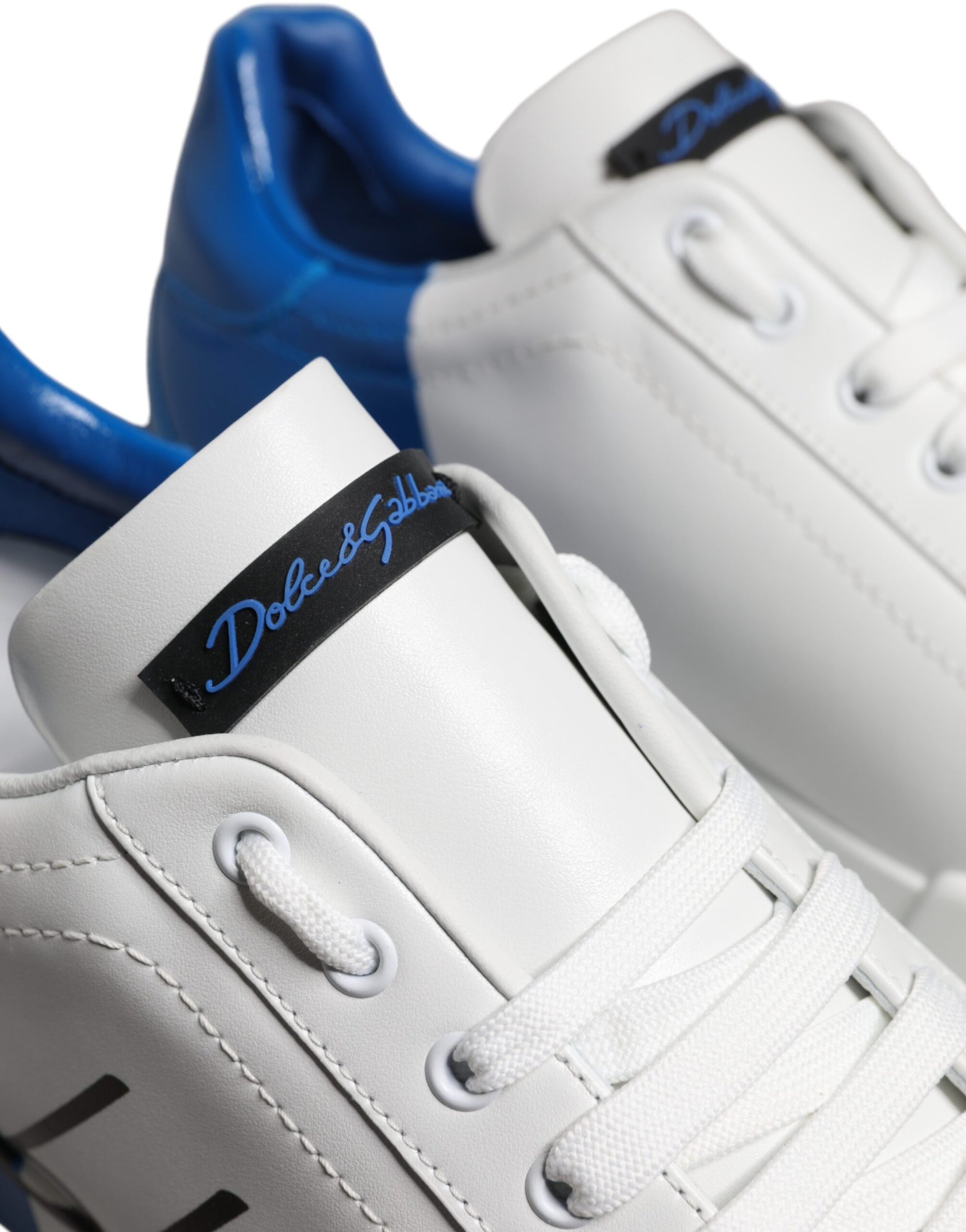 Pair of white and blue leather sneakers with logo on side