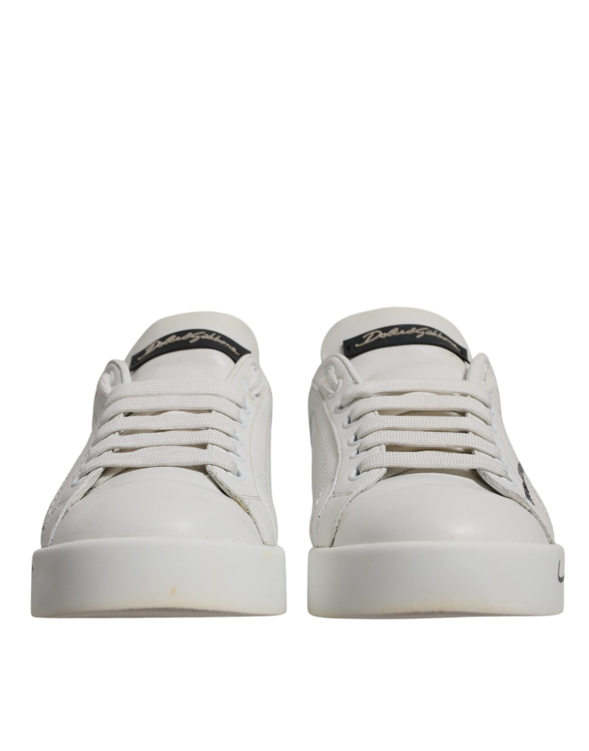 Pair of white sneakers with black laces