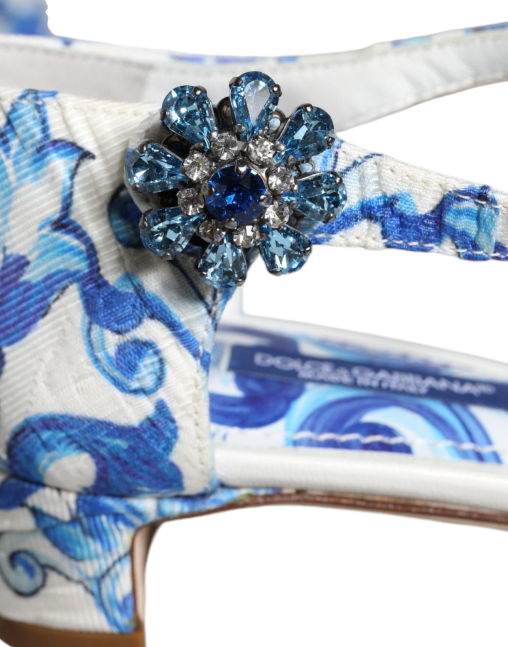 Blue and white high heel shoe with a large blue crystal embellishment on the toe