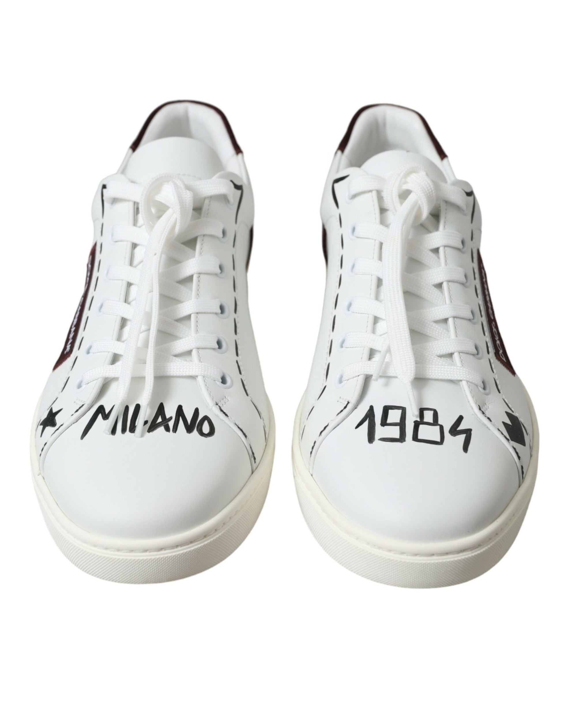 Pair of white sneakers with red laces and black soles
