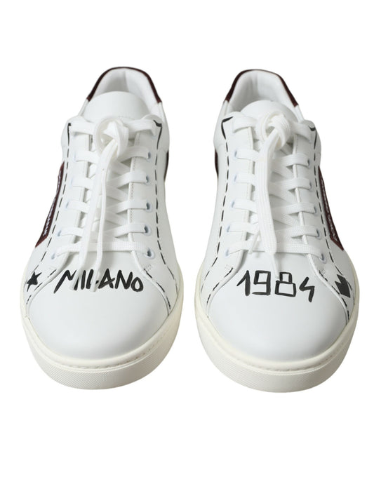 Pair of white sneakers with red laces and black soles