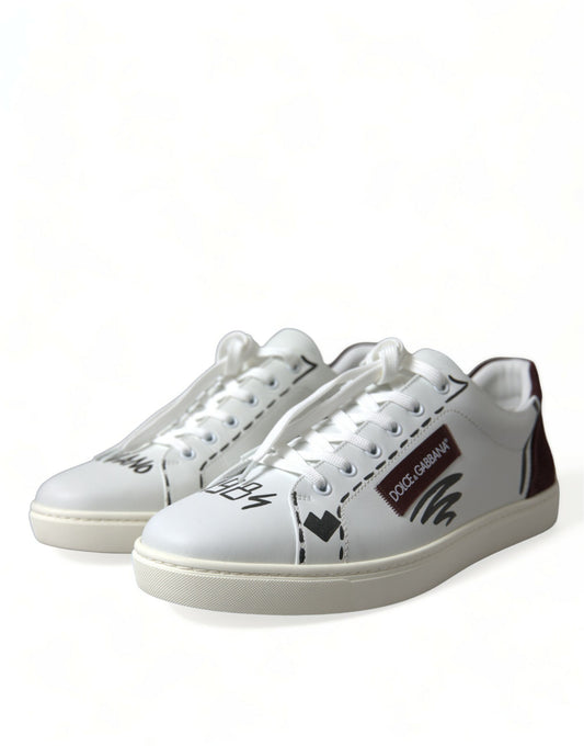 Pair of white sneakers with black laces and a red logo on the side