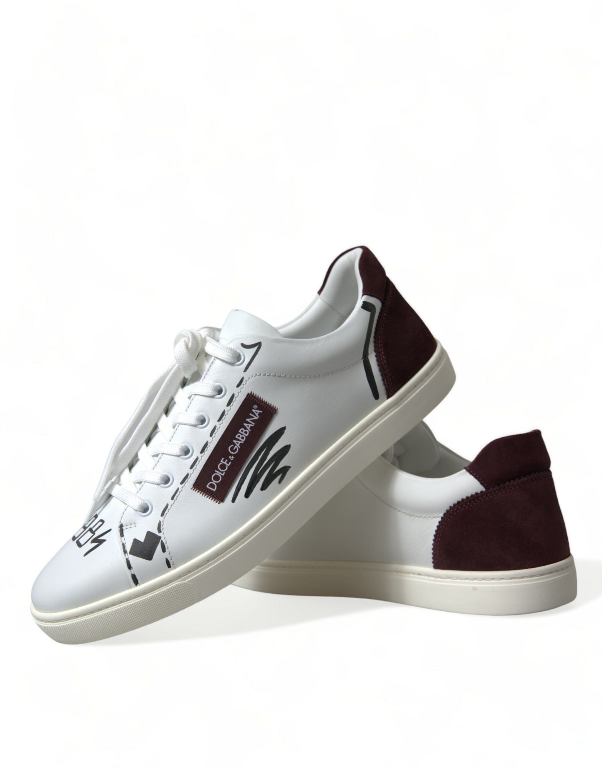 Pair of white sneakers with black laces and a red logo on the side
