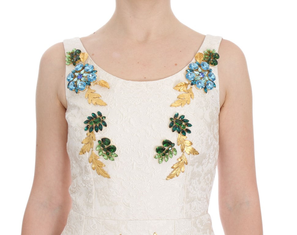 A white brocade dress with gold and crystal embellishments on the bodice