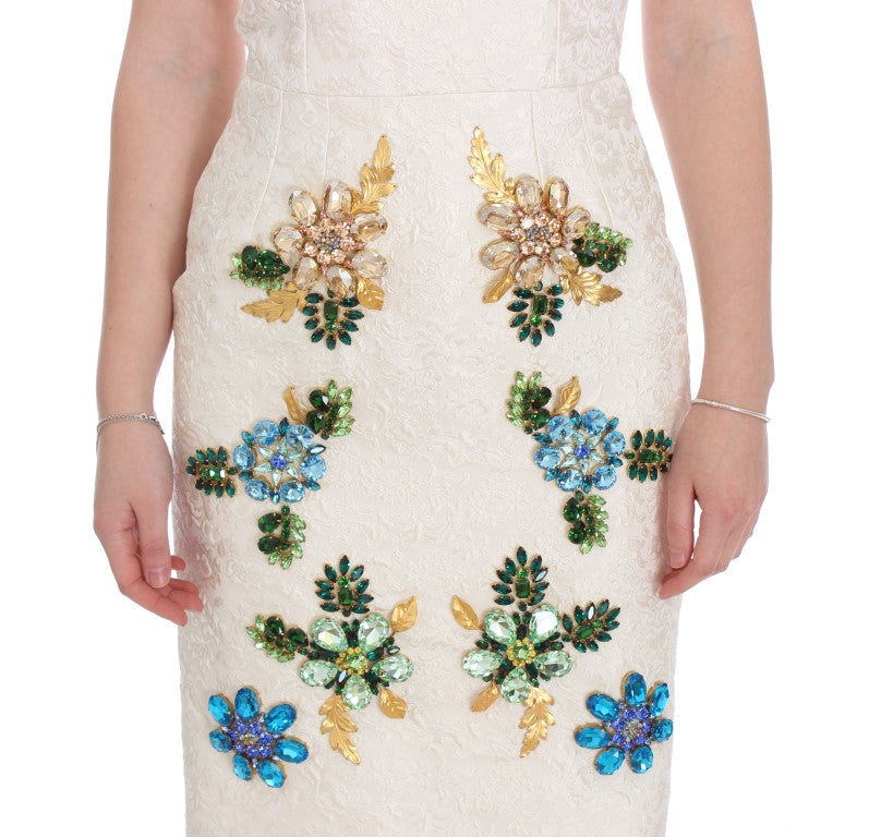 A white brocade dress with crystal embellishments on bodice and sleeves