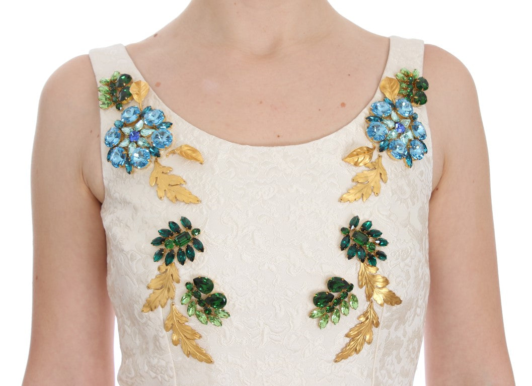 A white brocade dress with gold and blue crystals on the bodice