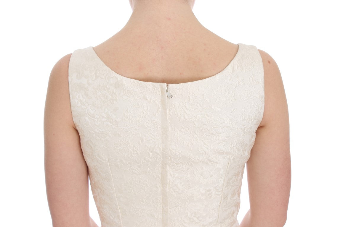 A white brocade dress with crystal embellishments, featuring a fitted bodice and long sleeves