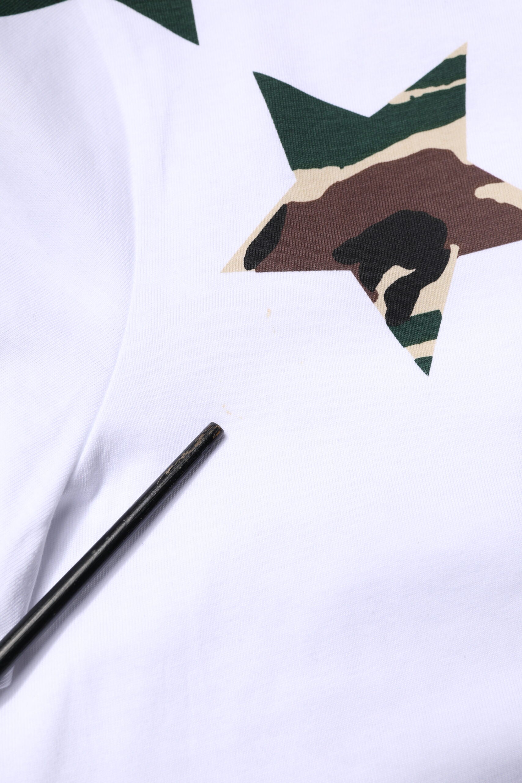White shirt with camouflage design on front