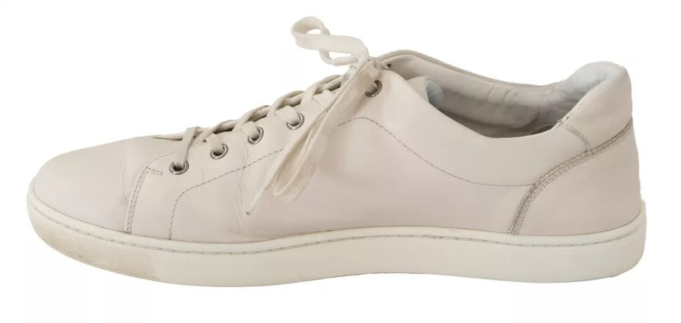 Pair of white casual leather sneakers with logo, laces and rubber sole