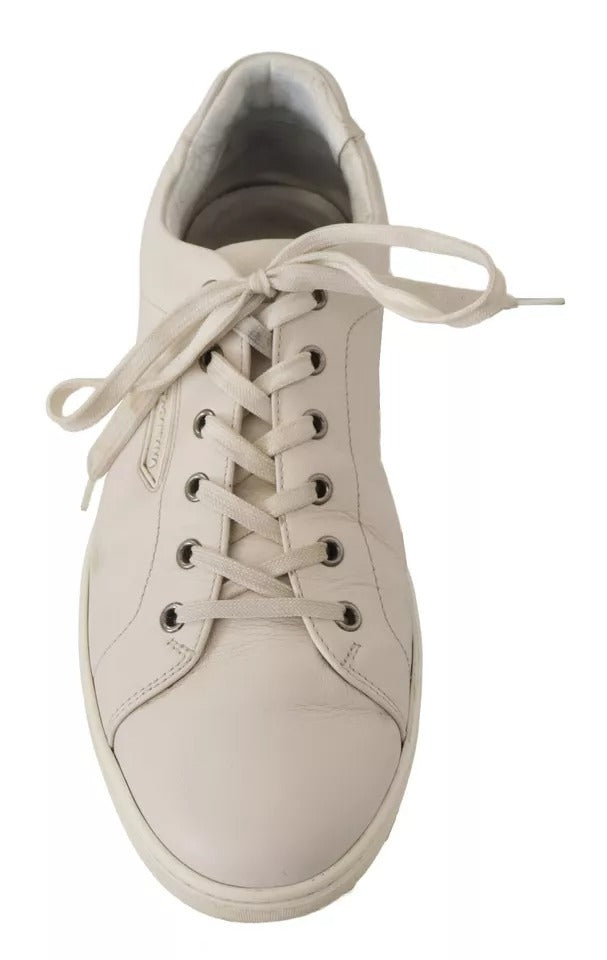 A pair of white casual leather sneakers with a logo on the side, designed for men