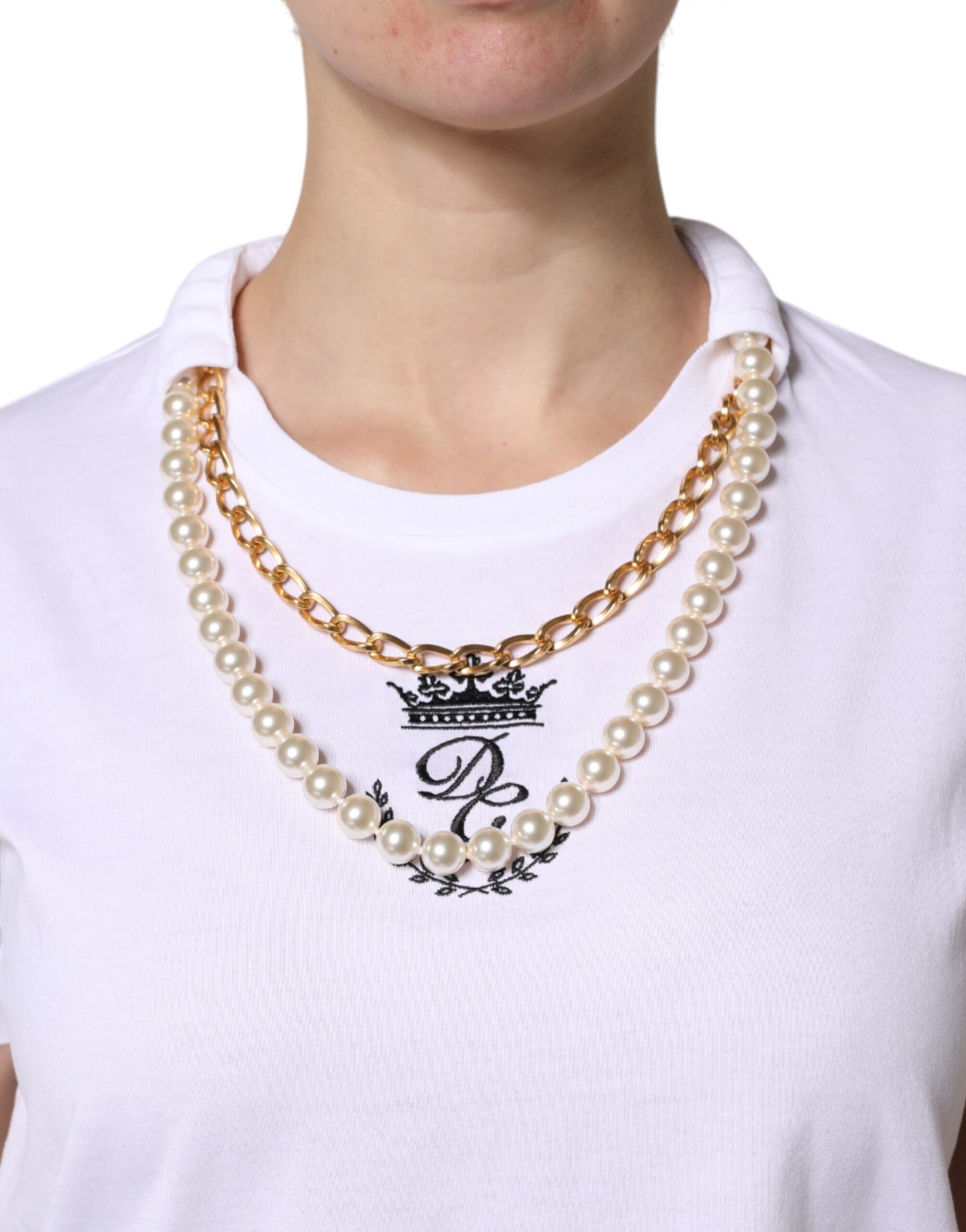 Woman wearing pearl necklace with monogrammed pendant