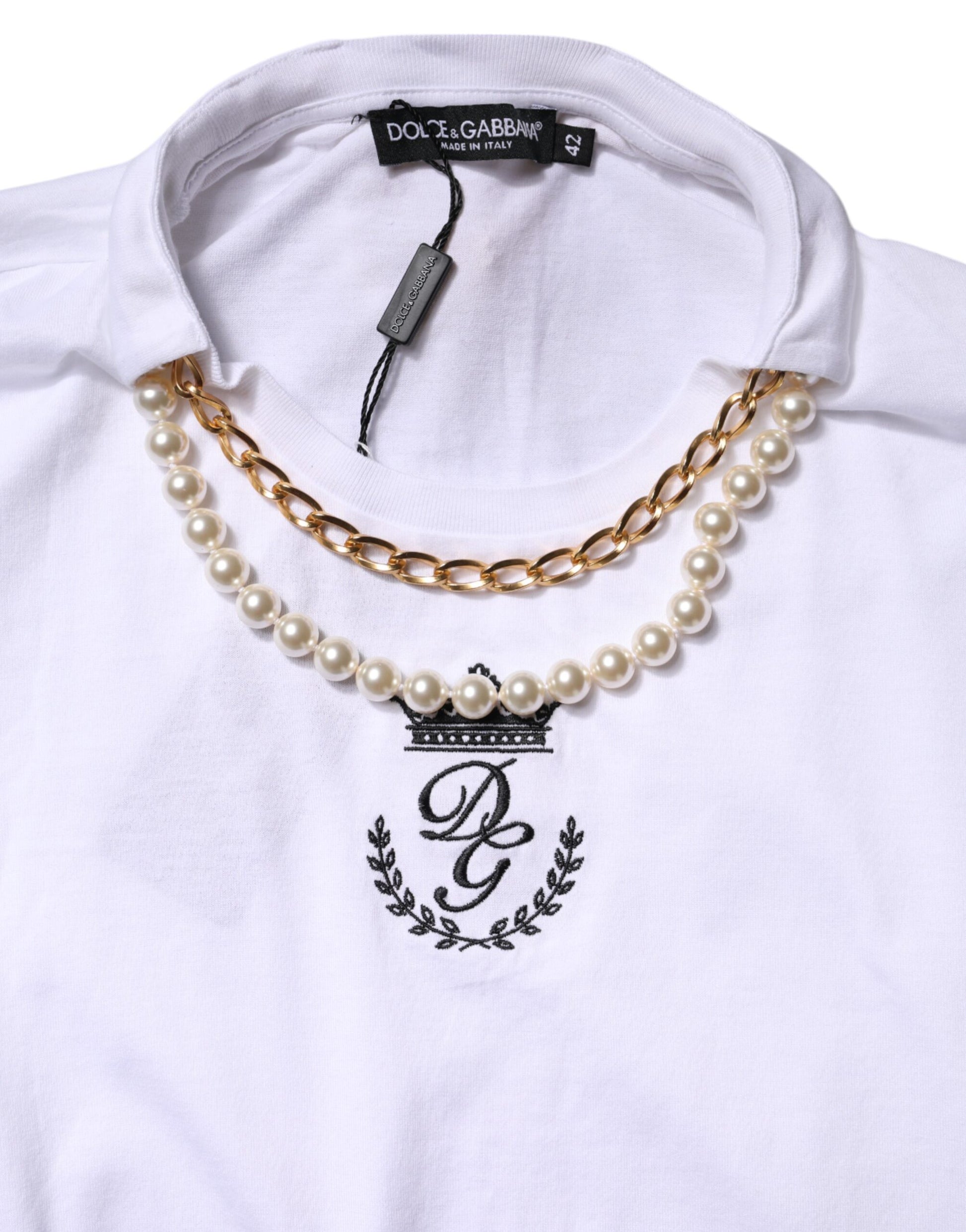 White t-shirt with black lettering and a pearl necklace