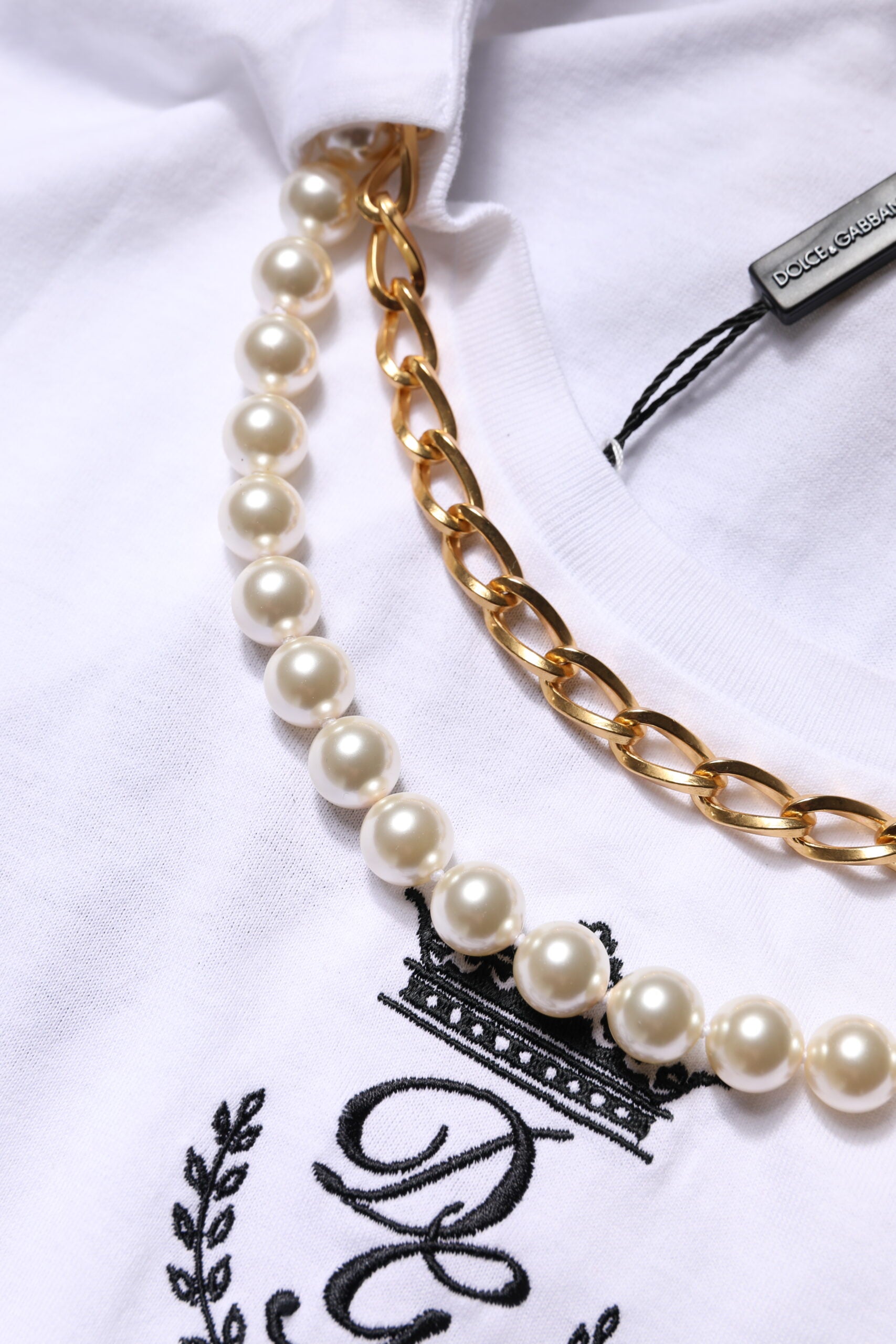 Necklace with pearls on a white shirt