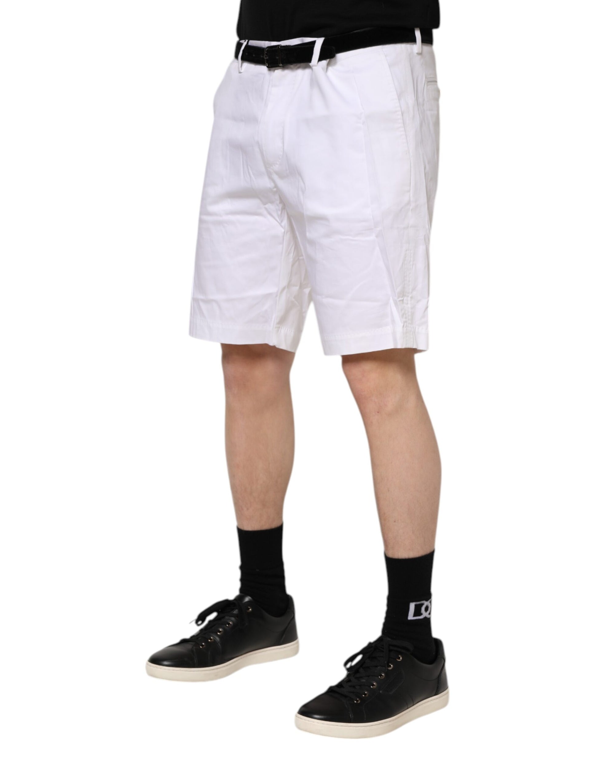 Man wearing white shorts and black shoes