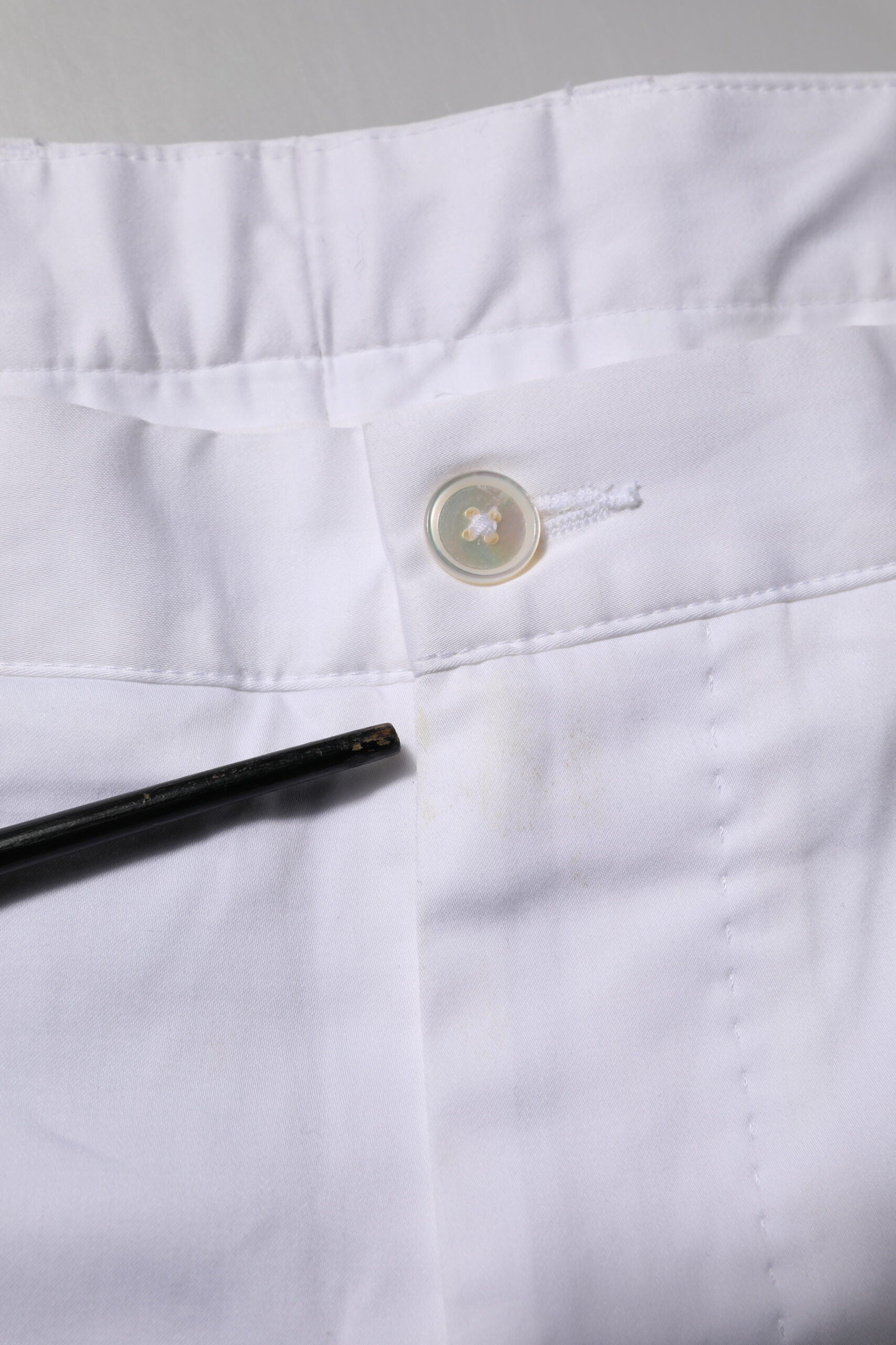 White pants with buttonhole