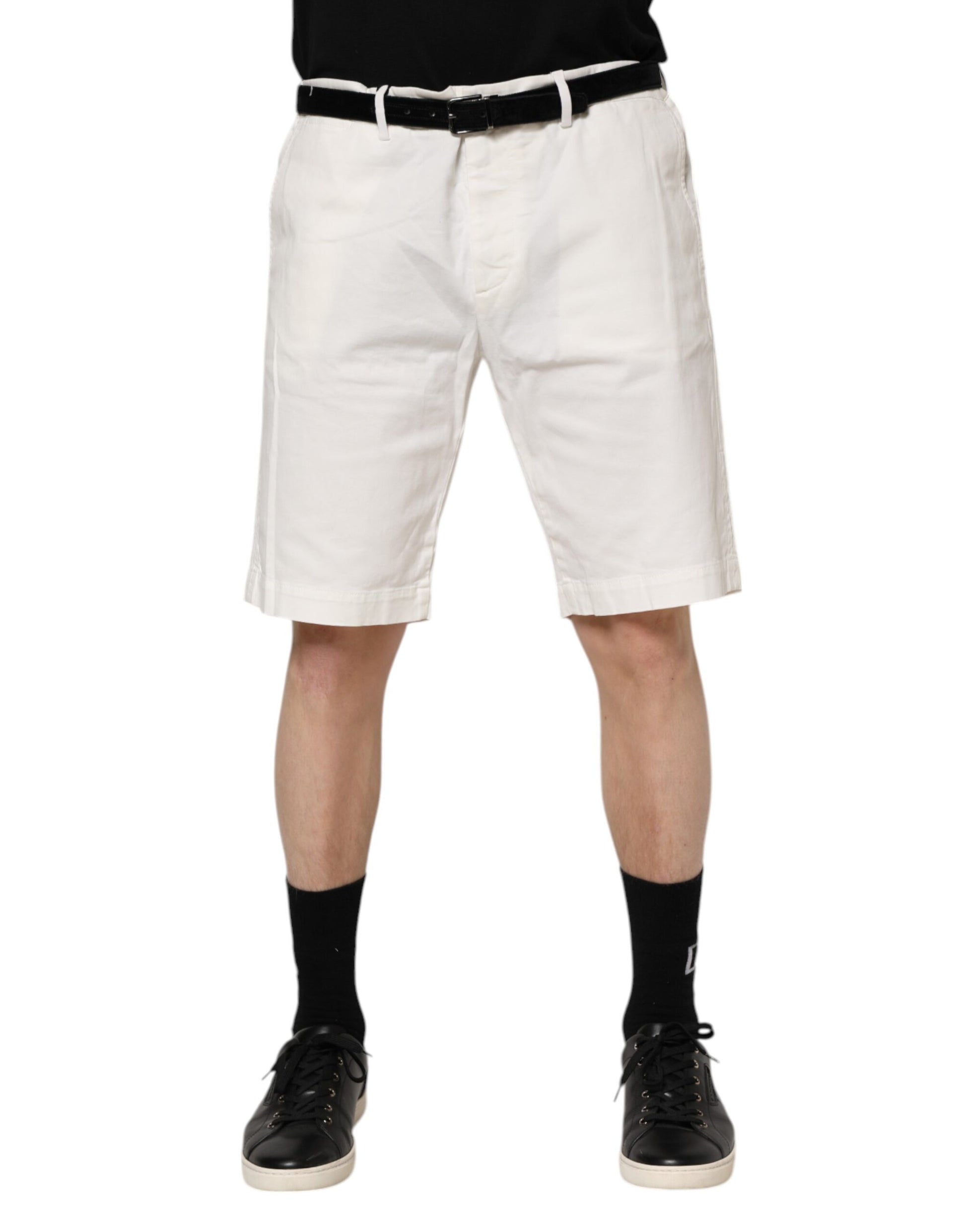 Man wearing white shorts and black shoes