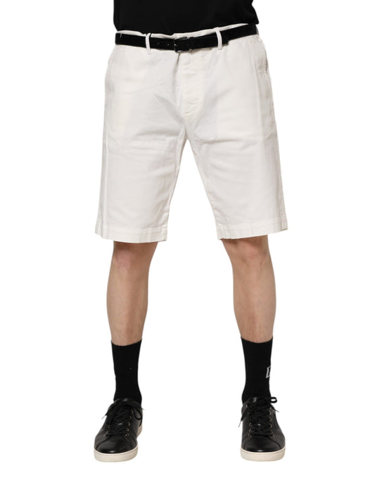 Man wearing white shorts and black shoes
