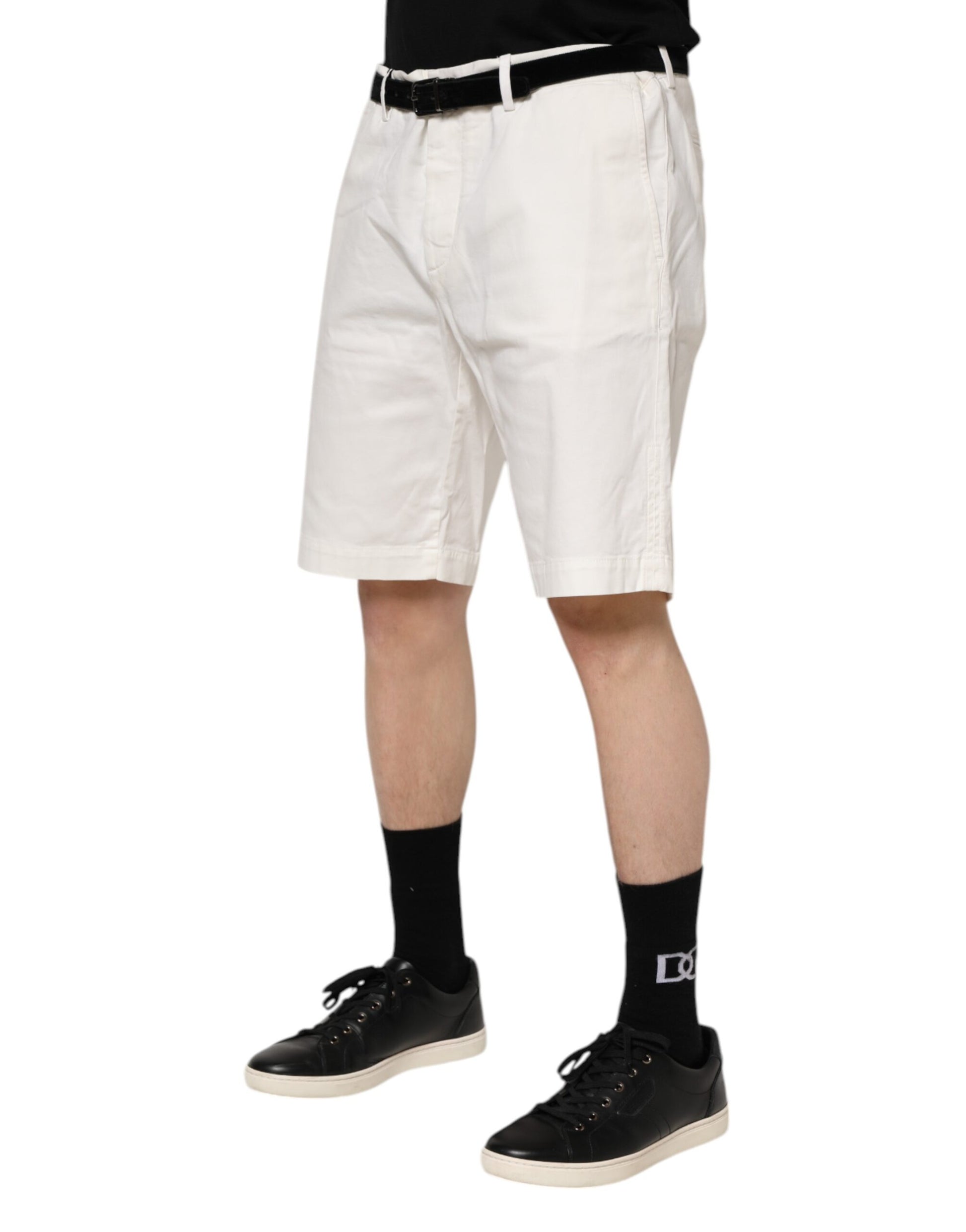 Man wearing white shorts and black shoes