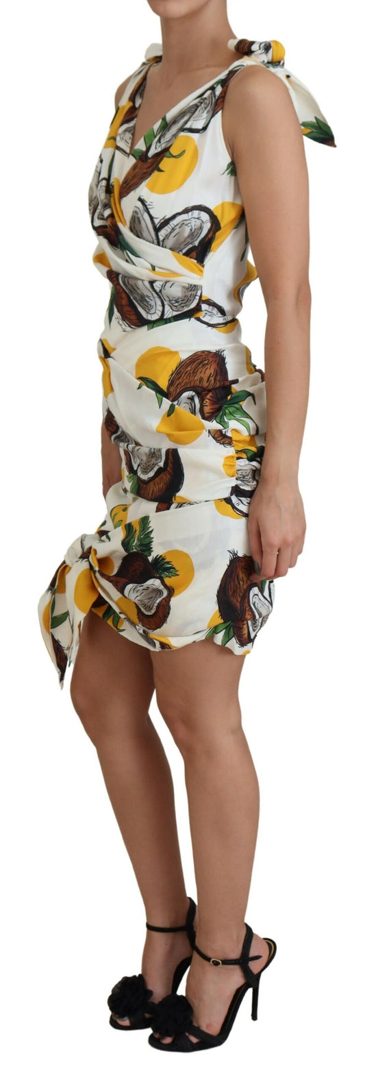 A woman wearing a white coconut print sheath mini silk dress