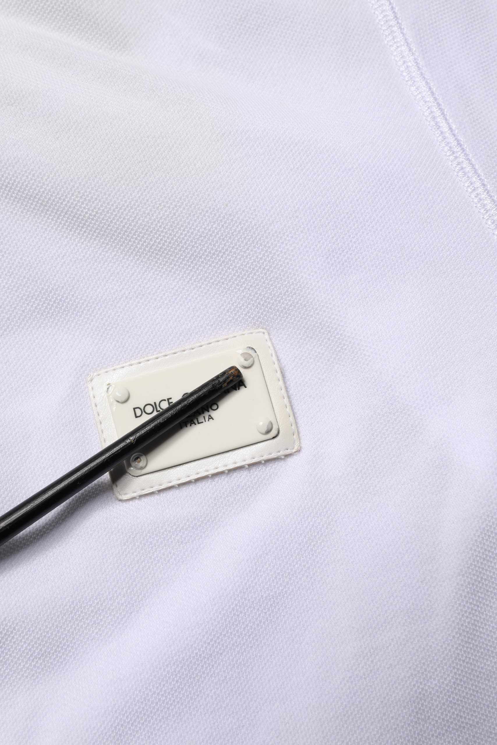 White shirt with black label on front