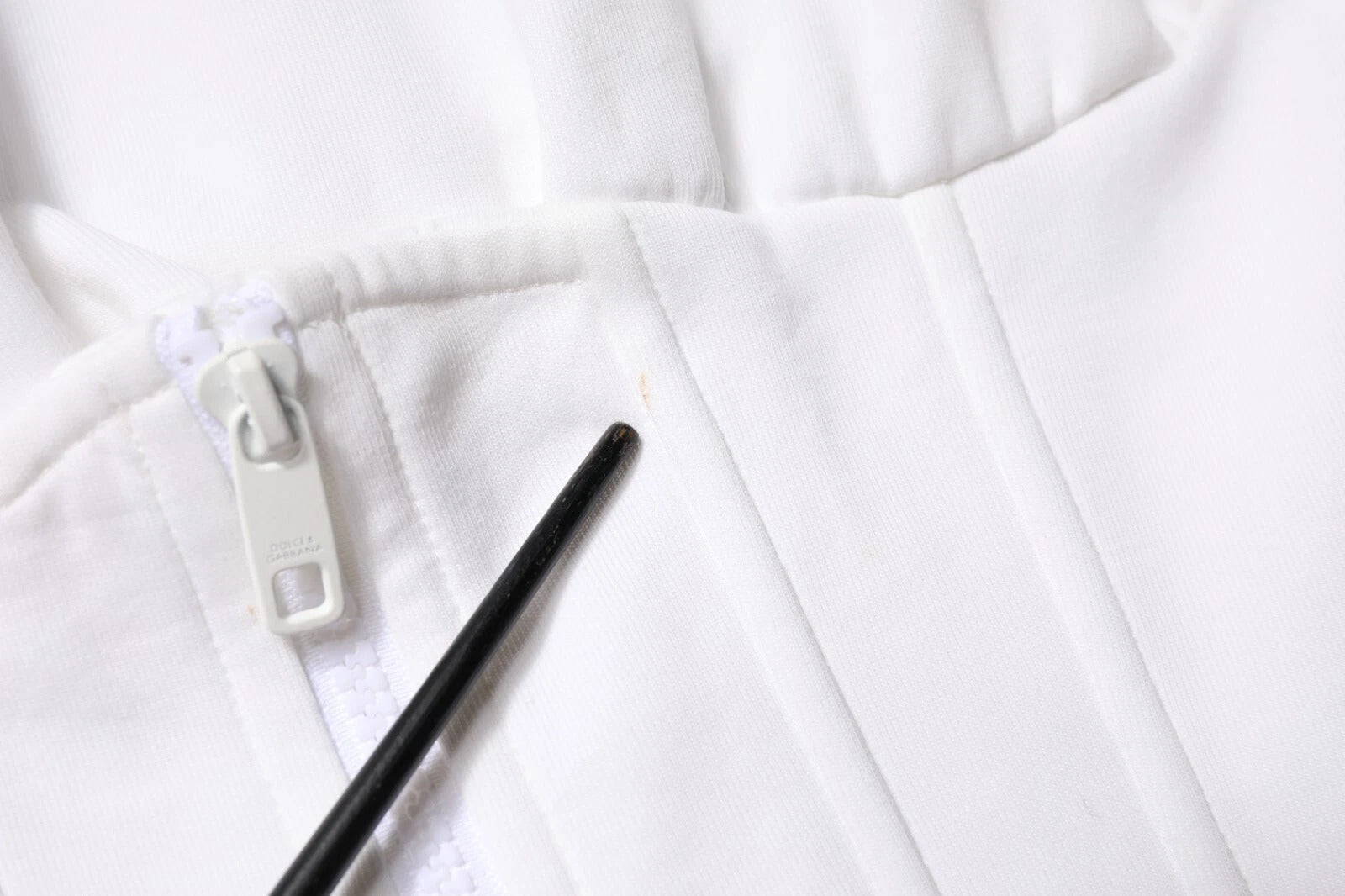 White fabric with black zipper pulls