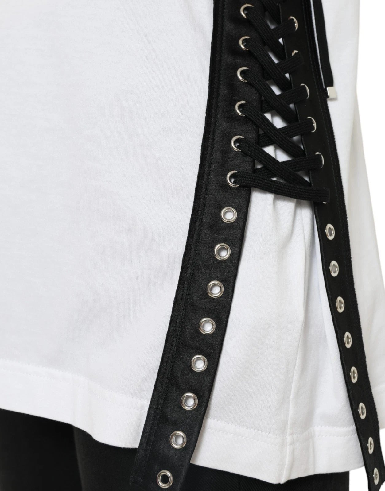 Black leather corset with silver studs on white shirt