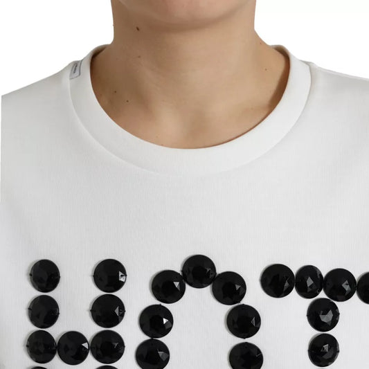 White sweater with black sequins spelling out "LOVE"