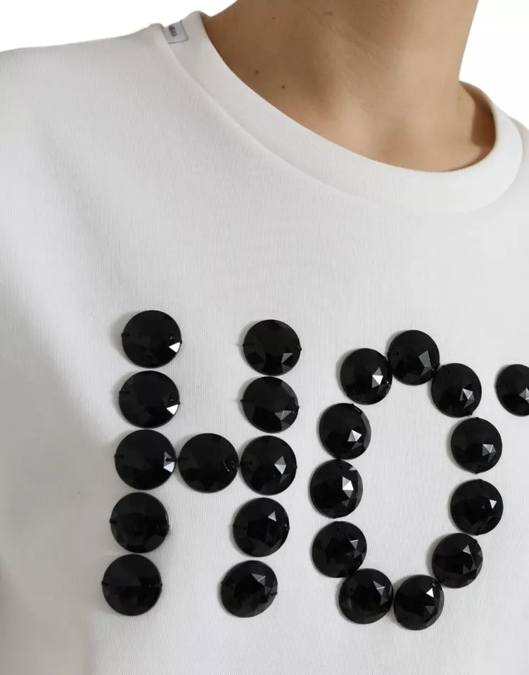 White sweatshirt with black lettering and embellishments