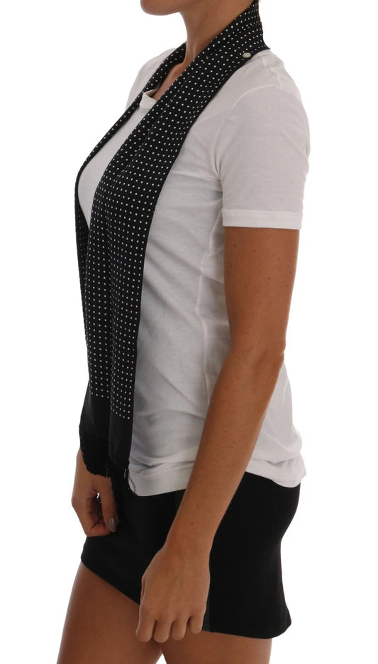 Woman wearing white shirt with black polka dots and a black scarf