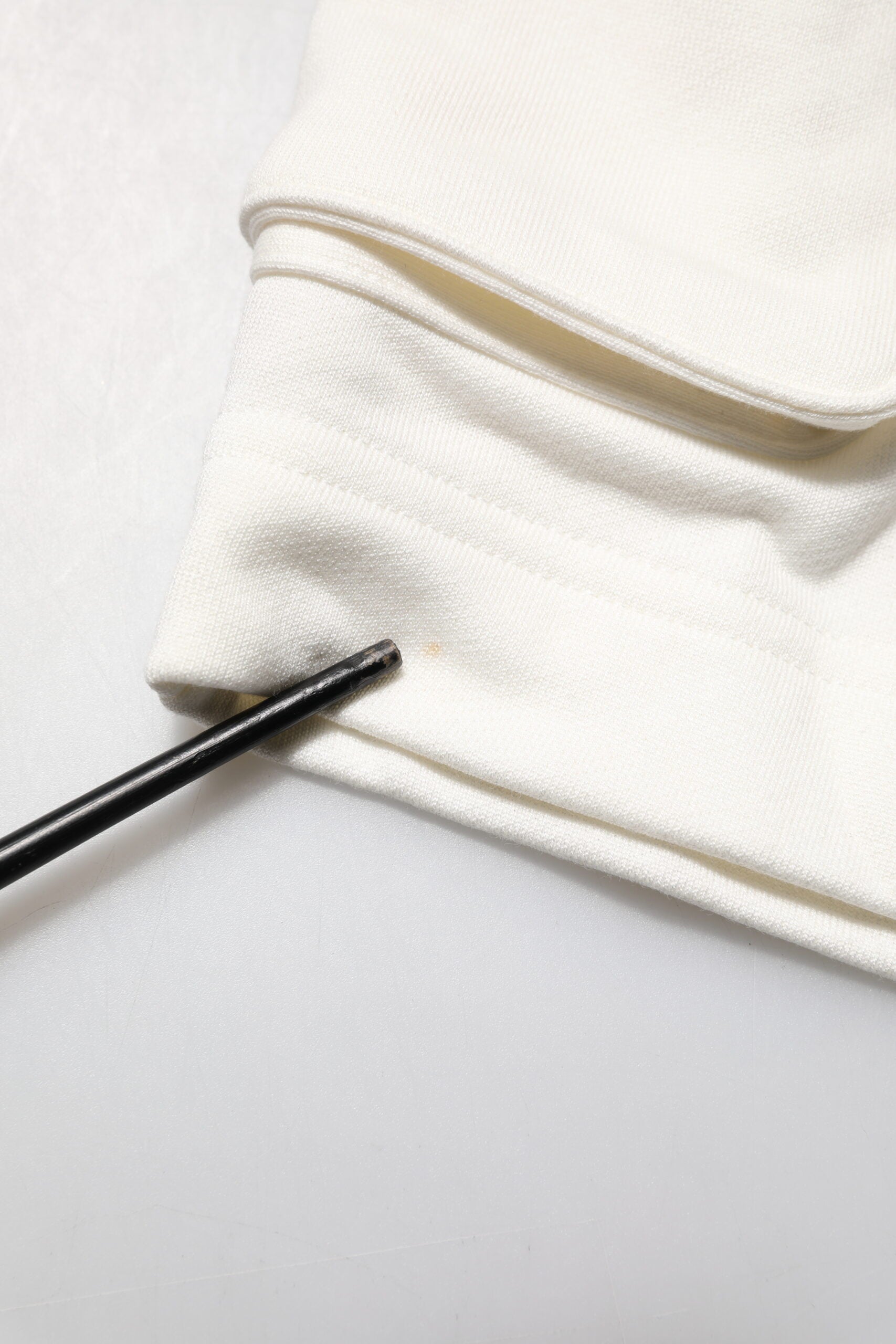 White fabric with black zipper