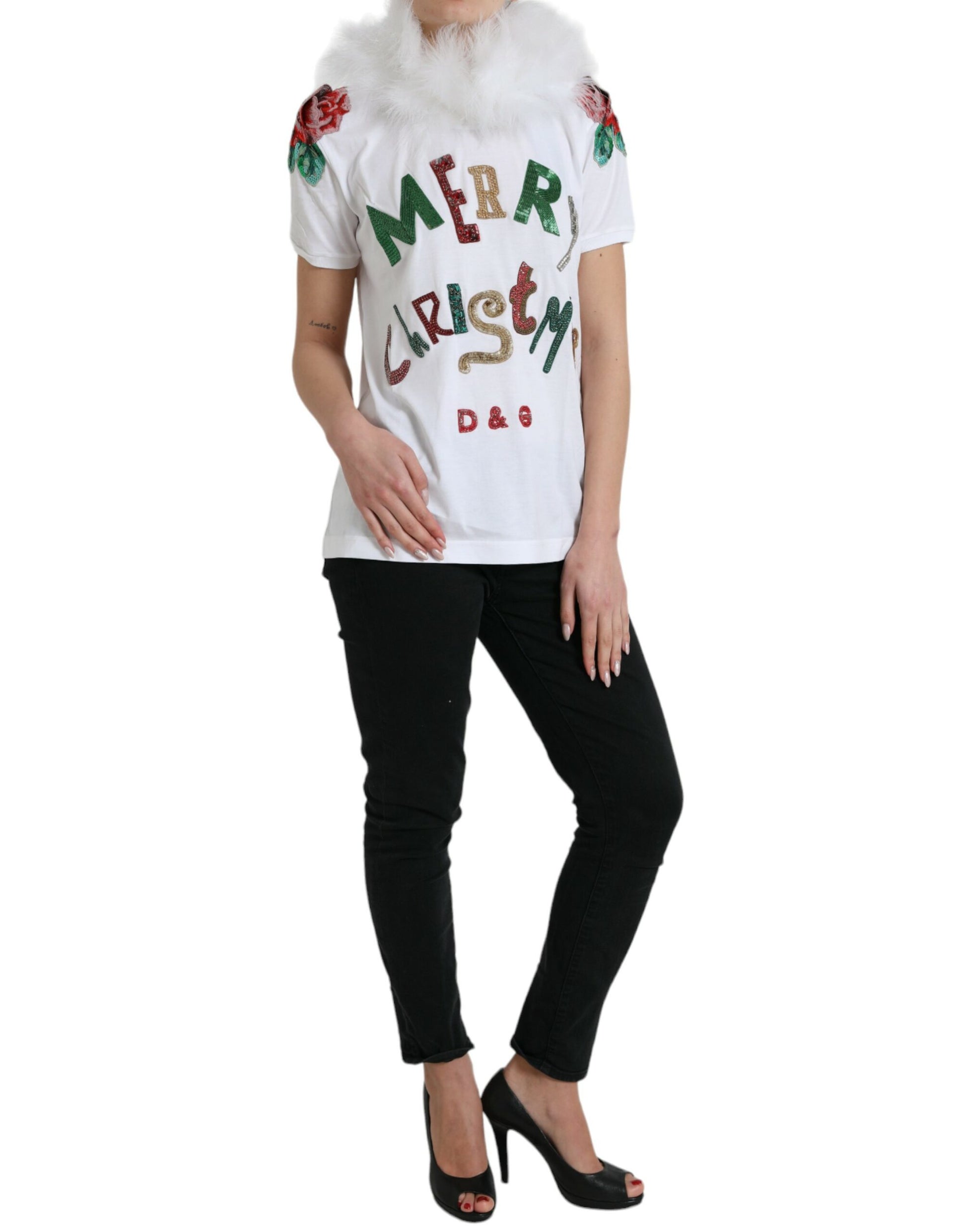 Woman wearing a white t-shirt with holiday design and black pants