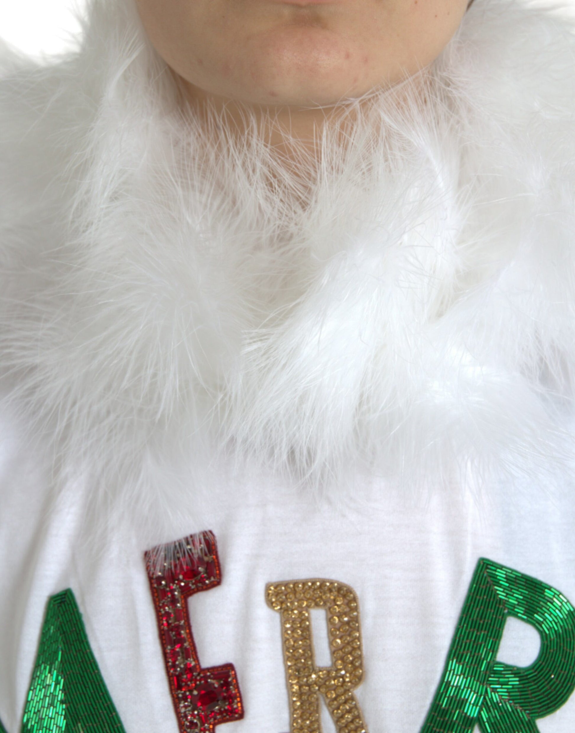 Man wearing white shirt with red glittery letters