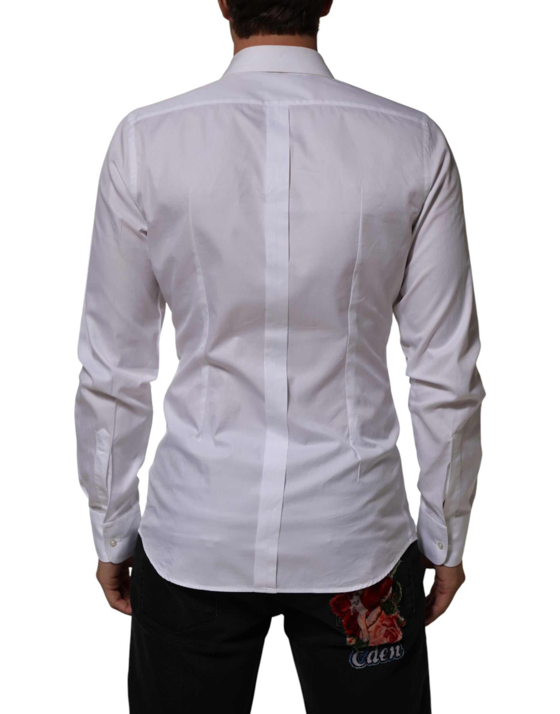 A white cotton collared bib shirt with a gold design on the front