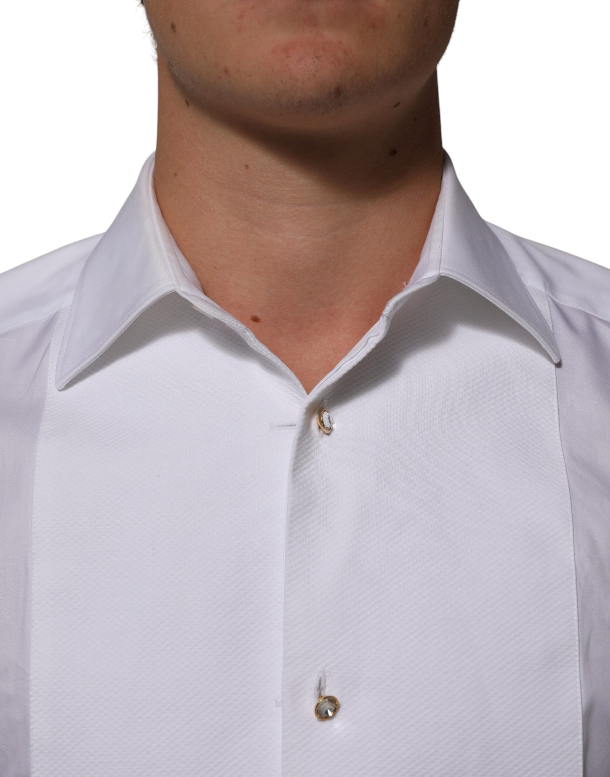 A white cotton collared bib shirt with a gold button