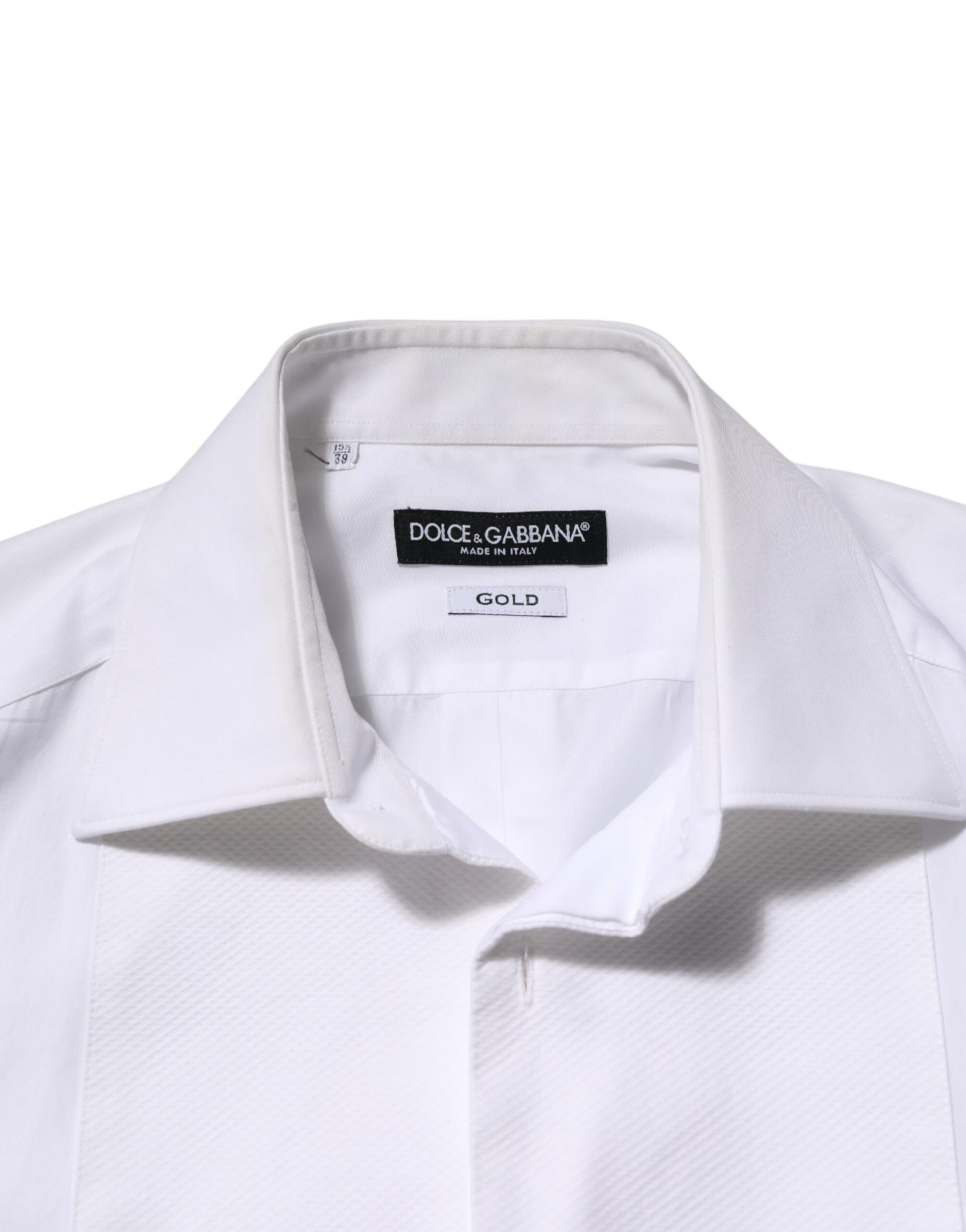 A white cotton collared bib shirt with a gold label on the neck
