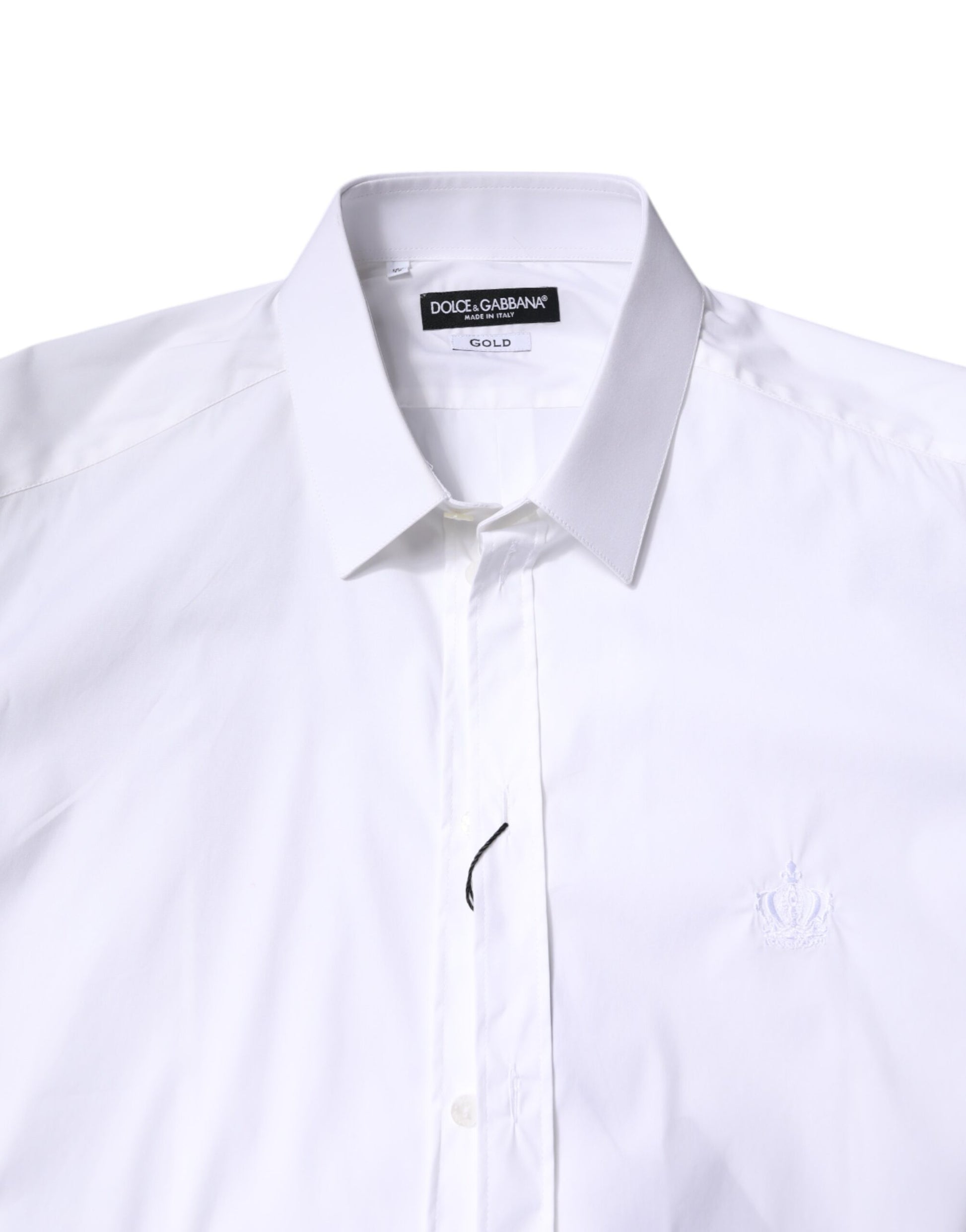 A white cotton collared shirt with a gold emblem on the left chest