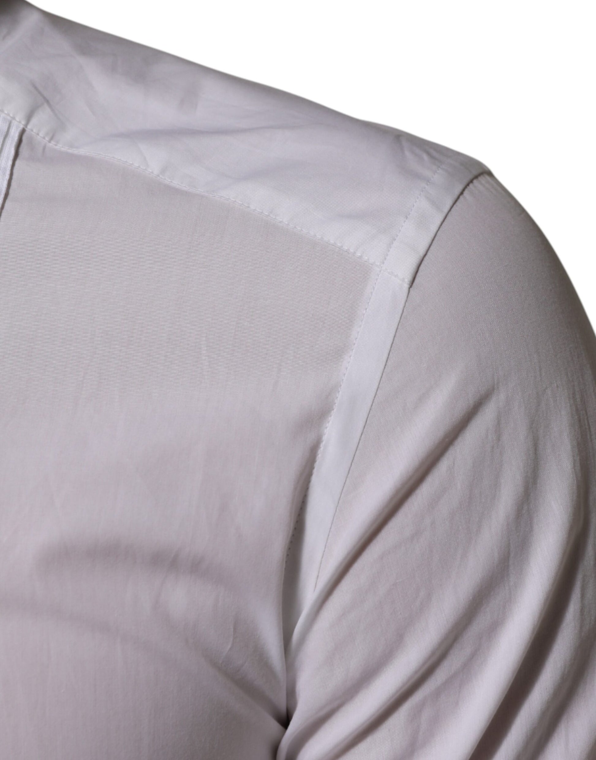 A white cotton collared long sleeve shirt with gold accents