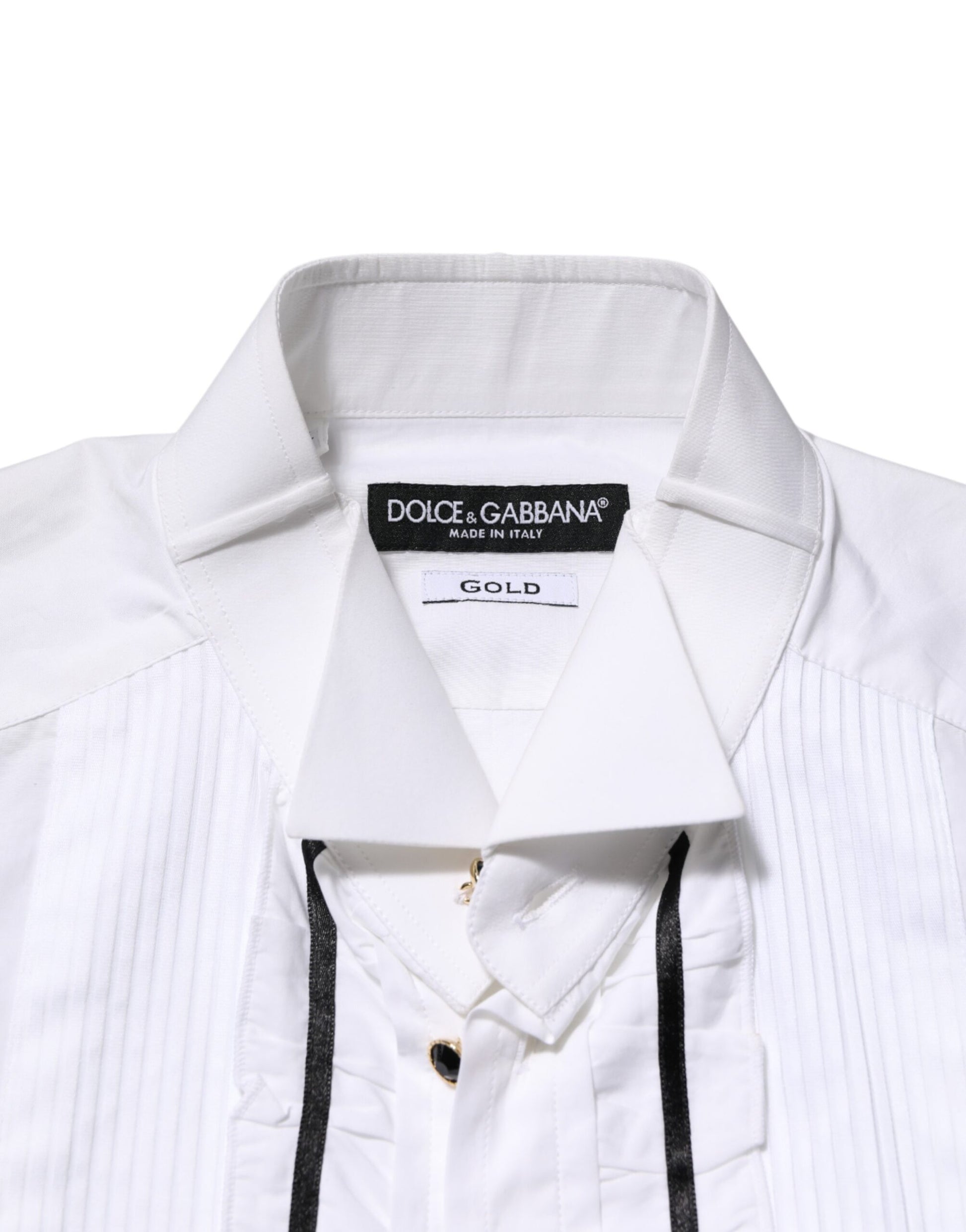 A white cotton collared long sleeve shirt with black trim and a gold label