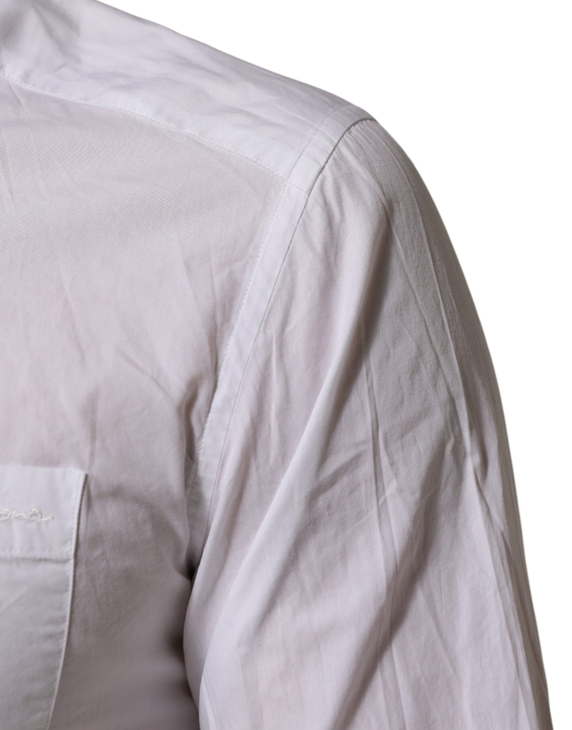 A white cotton collared dress shirt with a gold emblem on the left chest