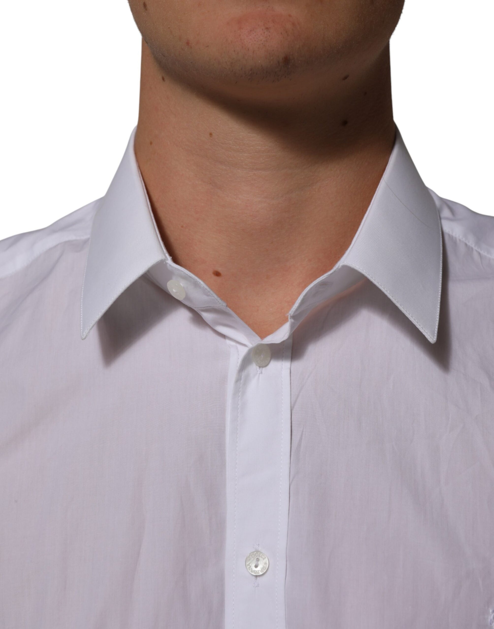 A man wearing a white collared dress shirt with a visible button-up front