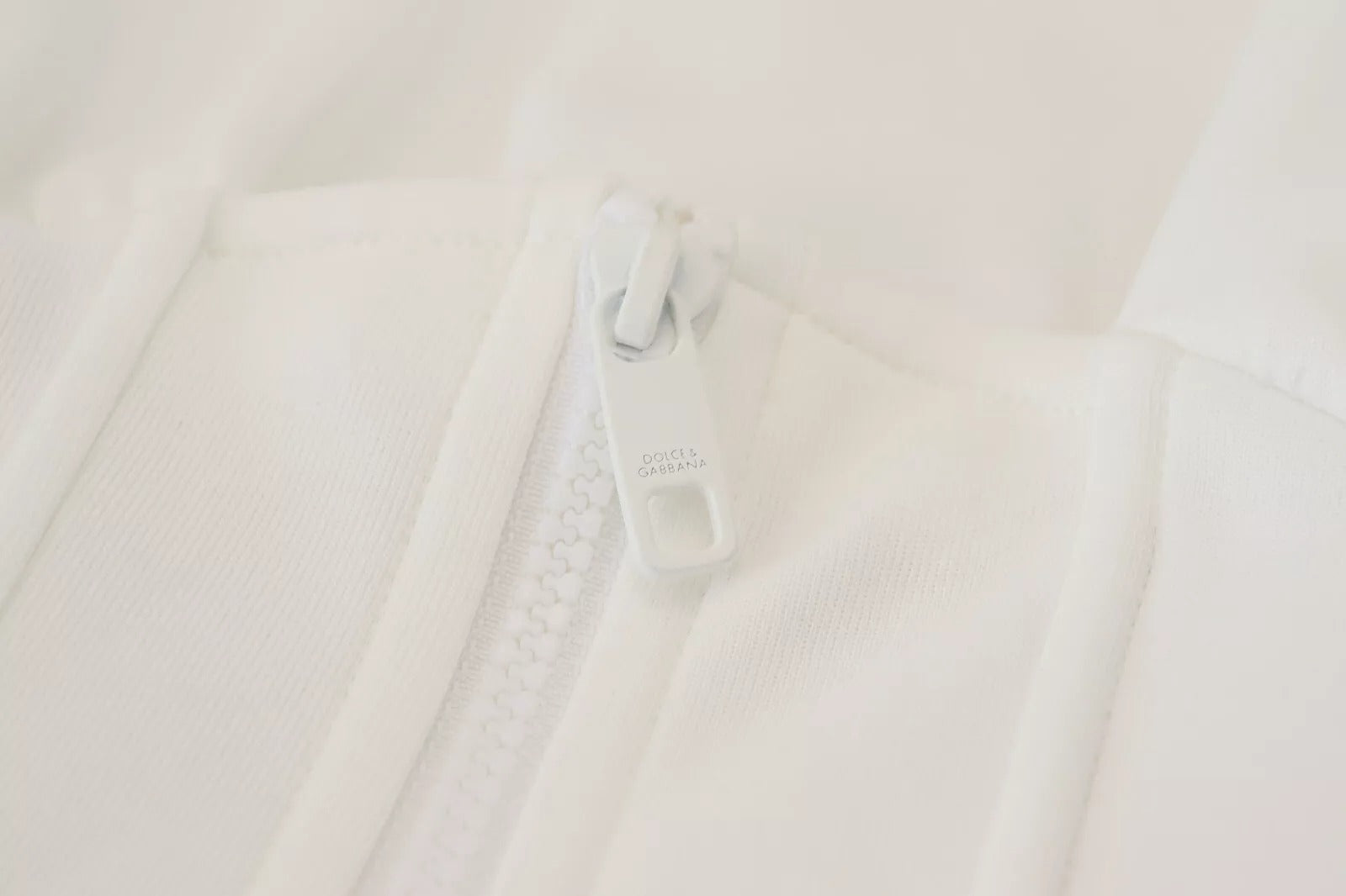 White garment with zipper on front