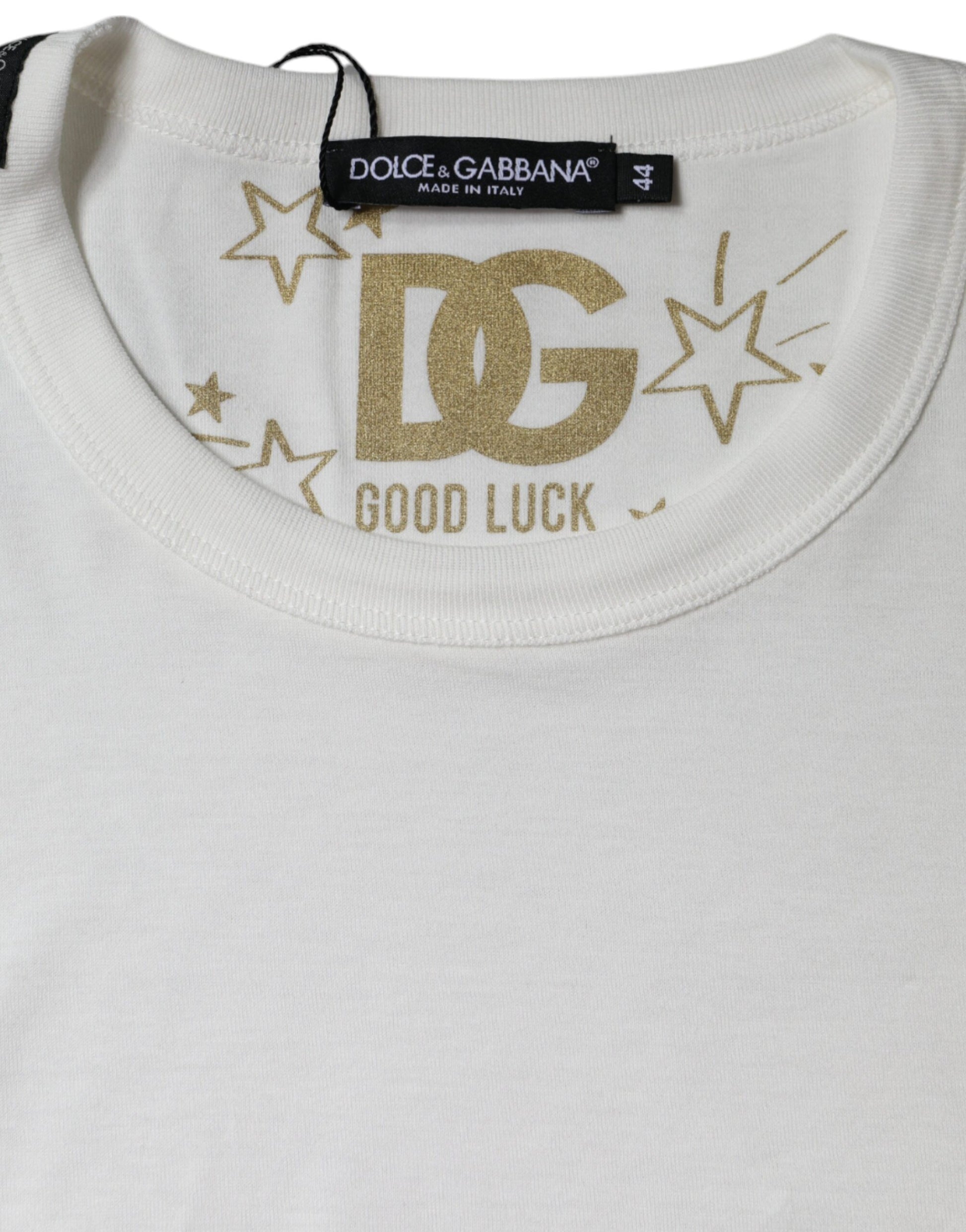 White t-shirt with gold lettering and stars