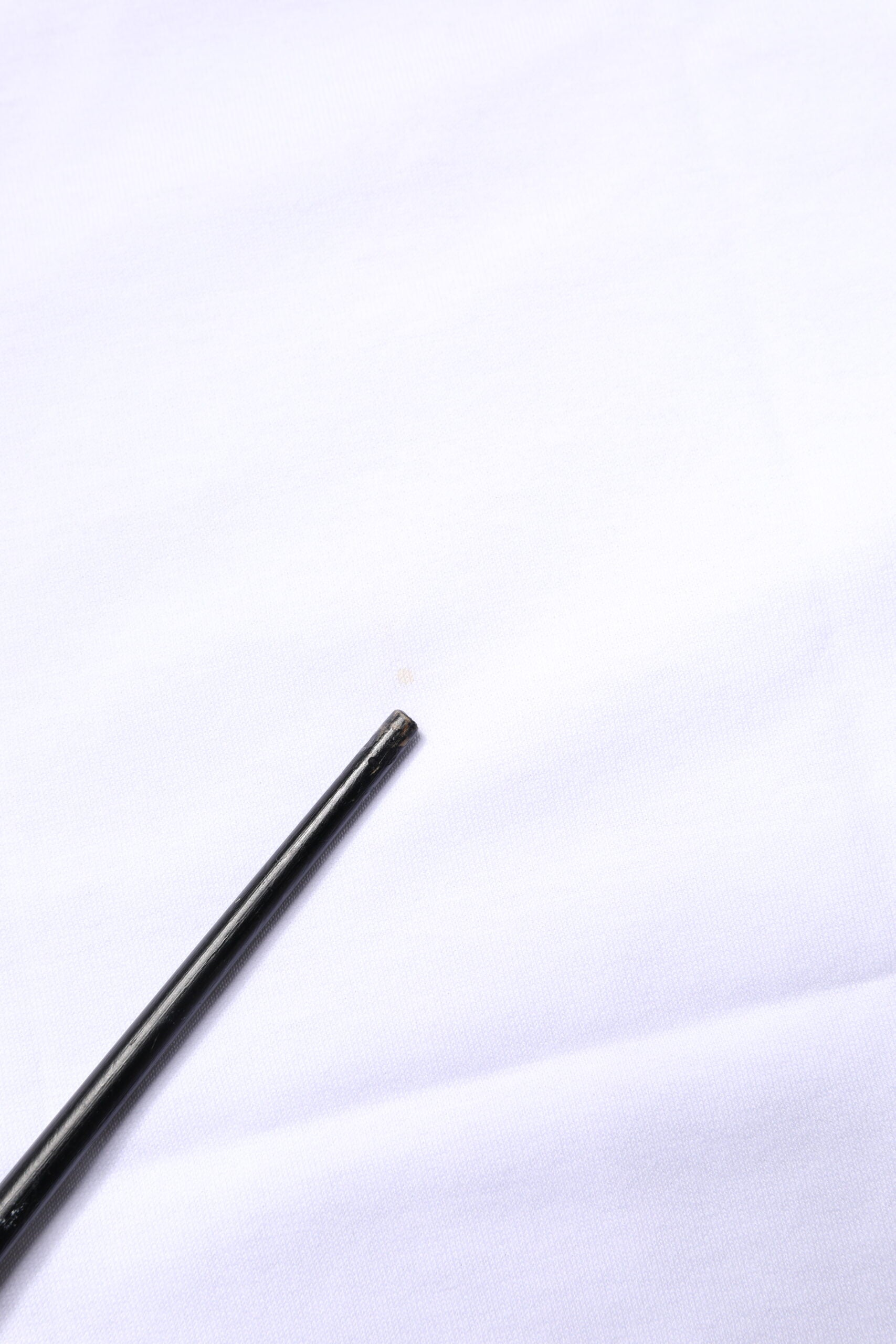Small black object on white surface