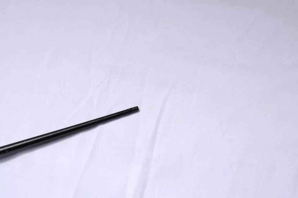 Two black pens on a white surface