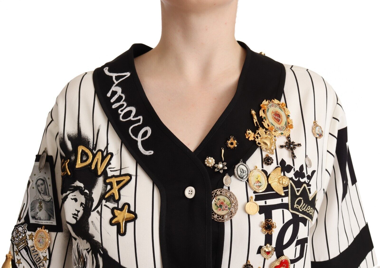 Black and white striped sweater with various pins and patches on front